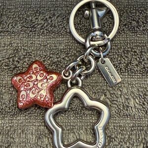 Coach Metal Signature Star bag charm silver hardware and pink petal glitter star